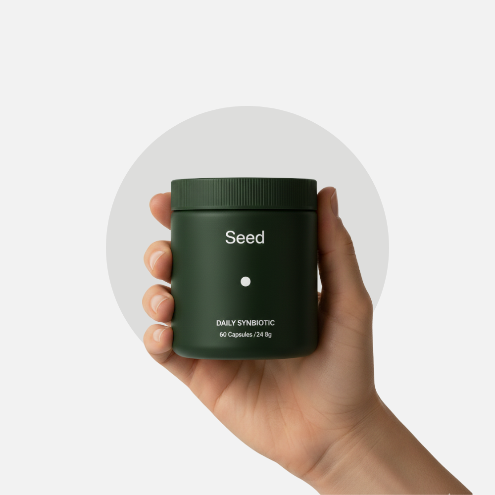 Hand holding the Daily Synbiotic jar
